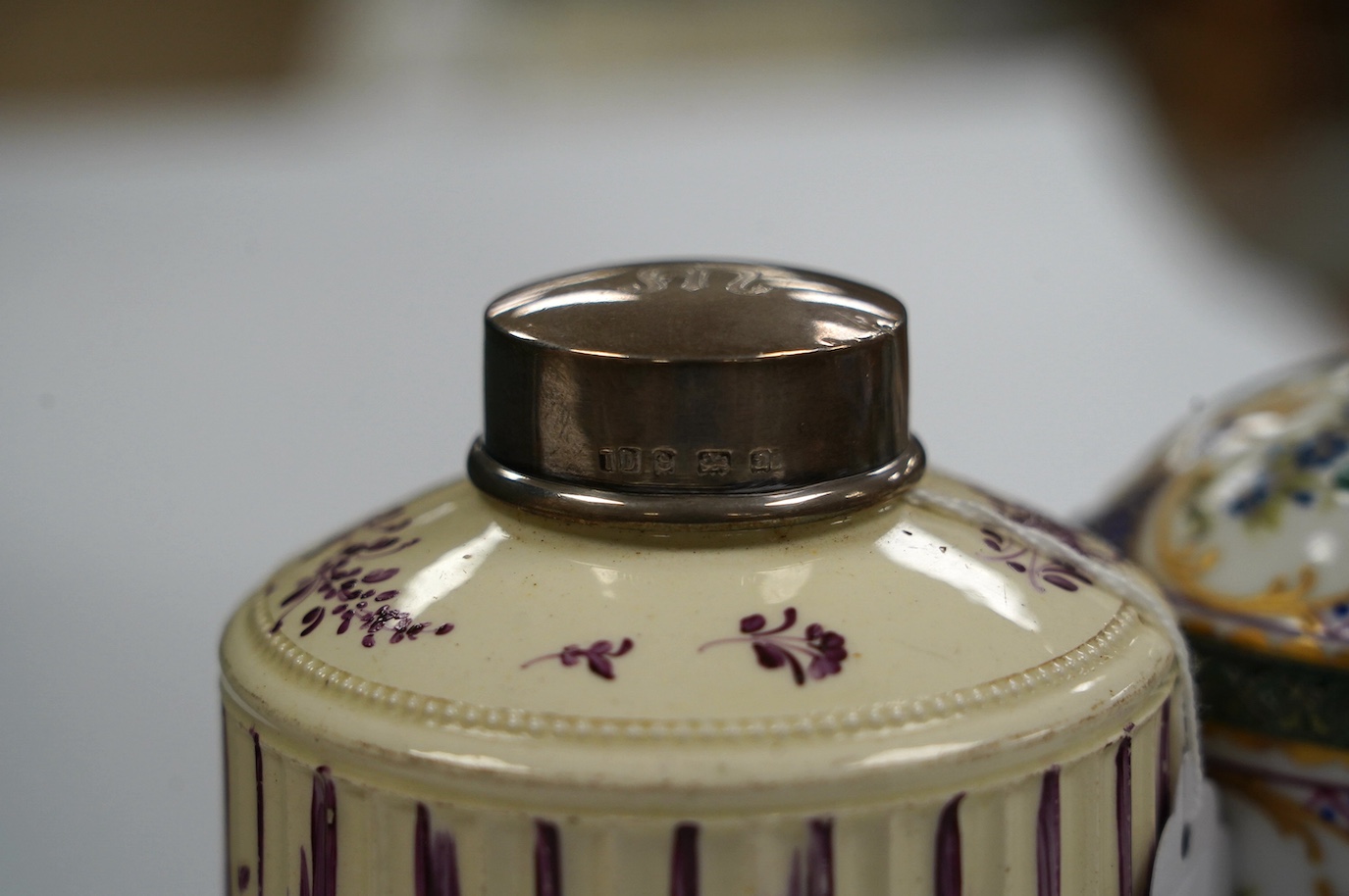 A Dresden porcelain ink stand, 11cm high, and an 18th century English creamware tea caddy with a silver lid, 10cm high. Condition - fair to good